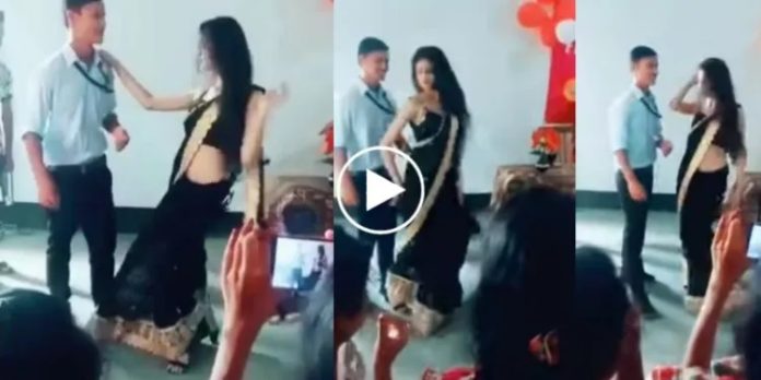 Video Beautiful dance by teacher in black saree, student standing nearby kept shy