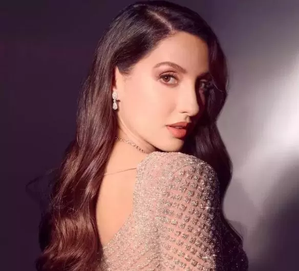 Nora Fatehi is wreaking havoc in a red gown, flaunts her curvy figure in front of the camera